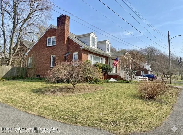 a view of a dining room with furniture a chandelier and wooden floor