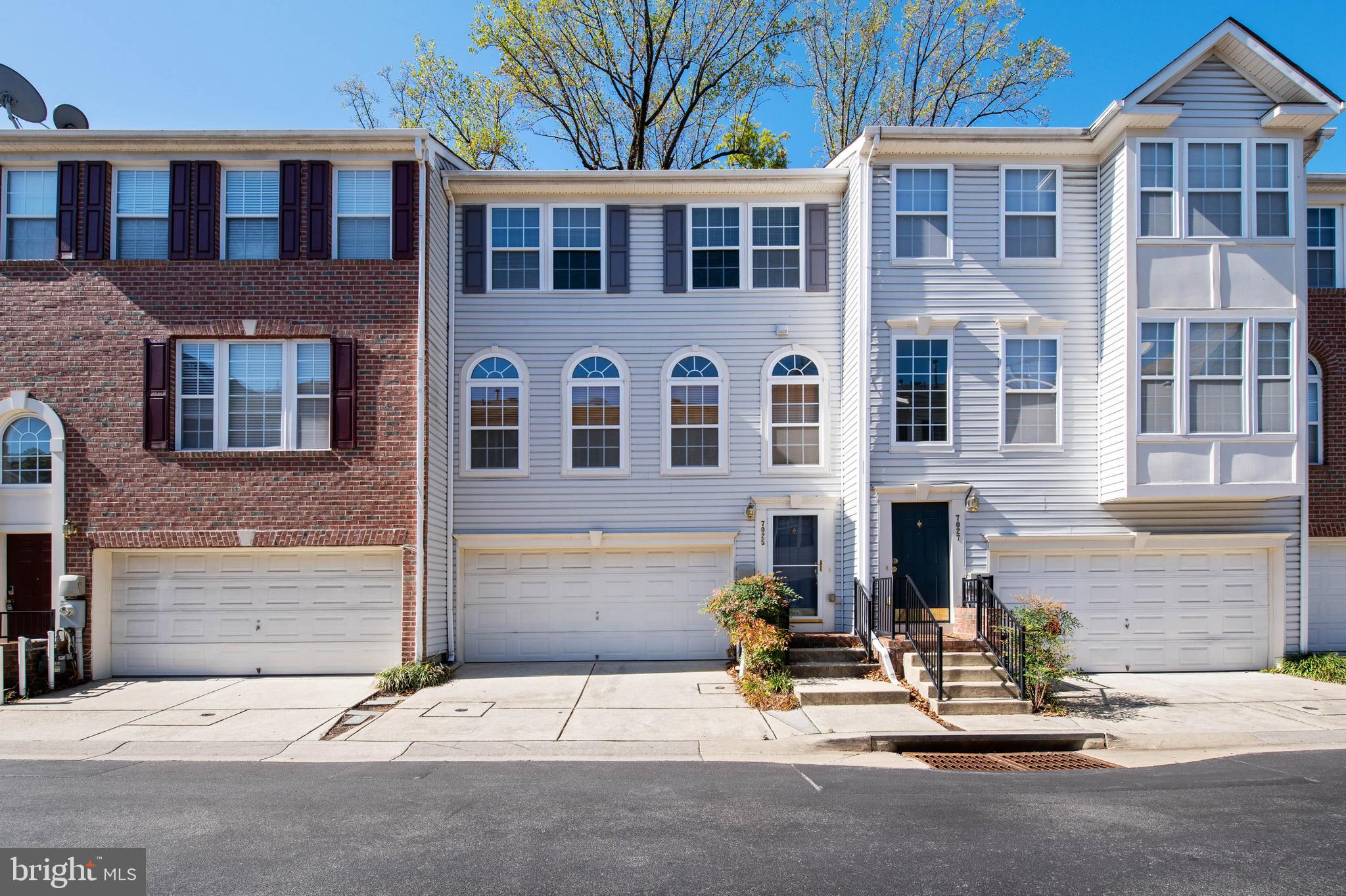 a front view of a building with a parking area
