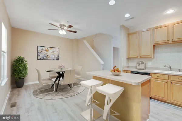 a kitchen with refrigerator a stove a sink dishwasher and a refrigerator with wooden floor