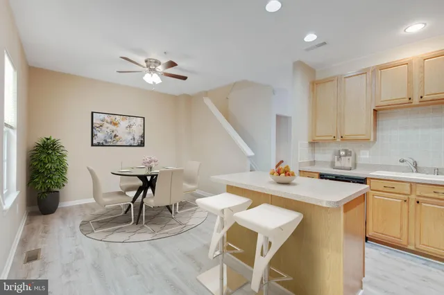 a kitchen with refrigerator a stove a sink dishwasher and a refrigerator with wooden floor