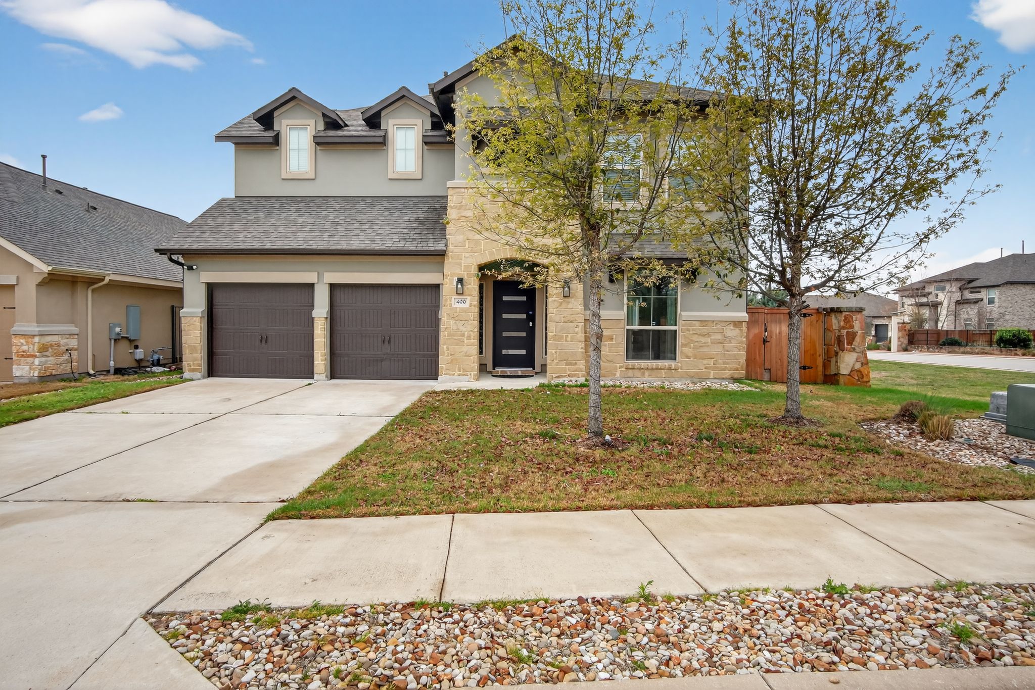 400 Cortona Lane Georgetown, TX 78628 - Photo 1 of 40 Traditional-style house featuring stone siding, a front yard, driveway, and stucco siding