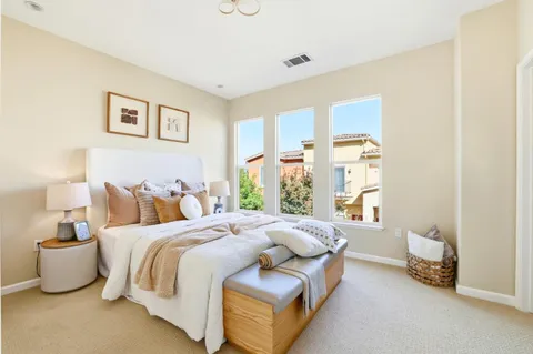 a bedroom with bed and a couch