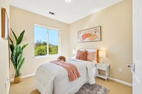 a bed sitting in a bedroom next to a window