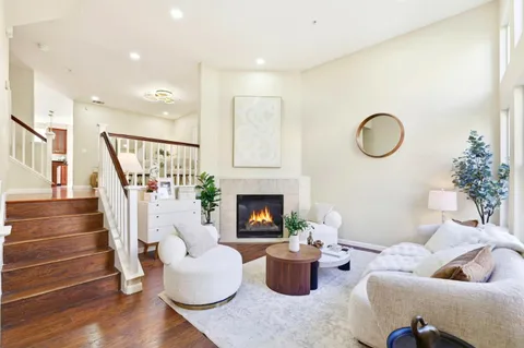 a living room with furniture potted plant and a fireplace
