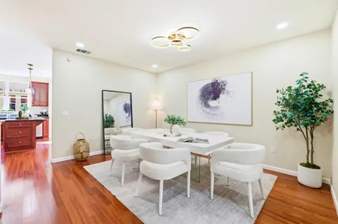 a dining room with furniture and wooden floor