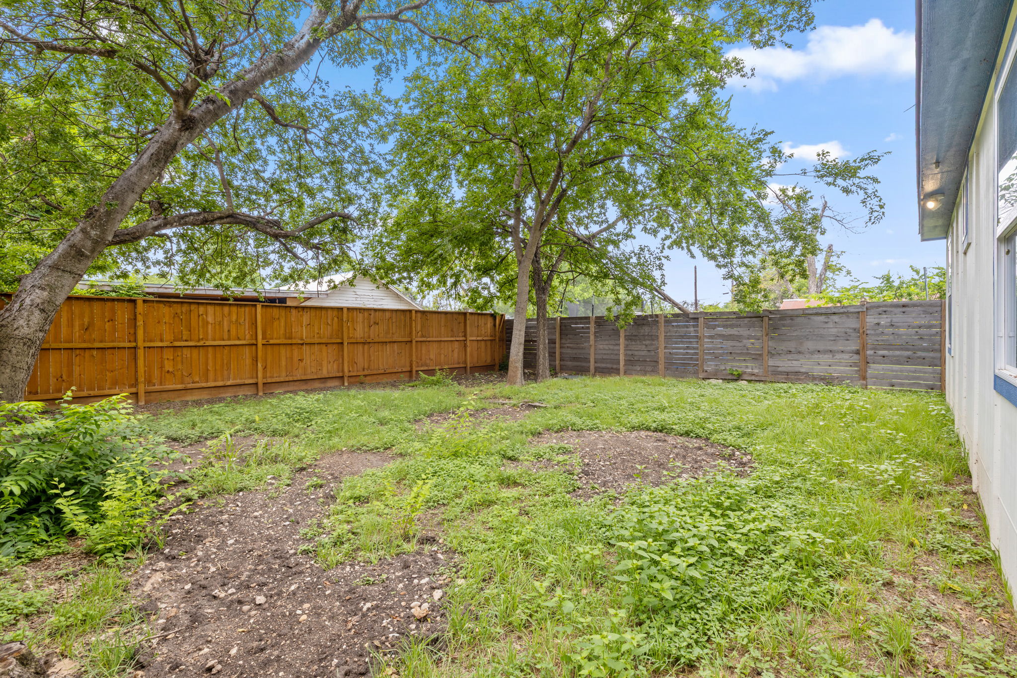 907 East 53rd Street Austin, TX 78751 - Photo 32 of 36 A generous backyard provides ample space for outdoor activities, enclosed by a private fence.