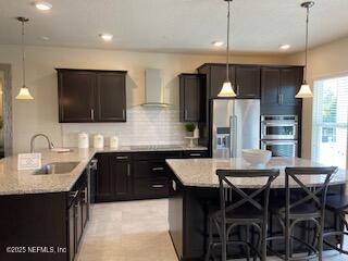 a kitchen with stainless steel appliances a dining table chairs refrigerator and microwave
