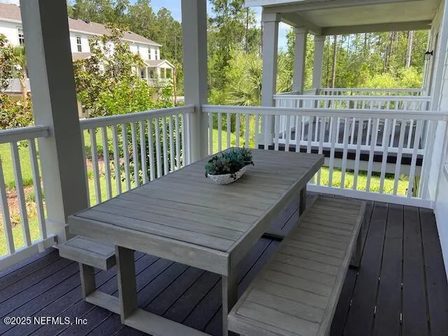 a view of balcony with wooden floor