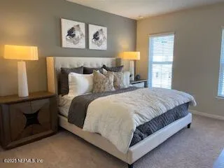 a large bed sitting in a bedroom next to a window