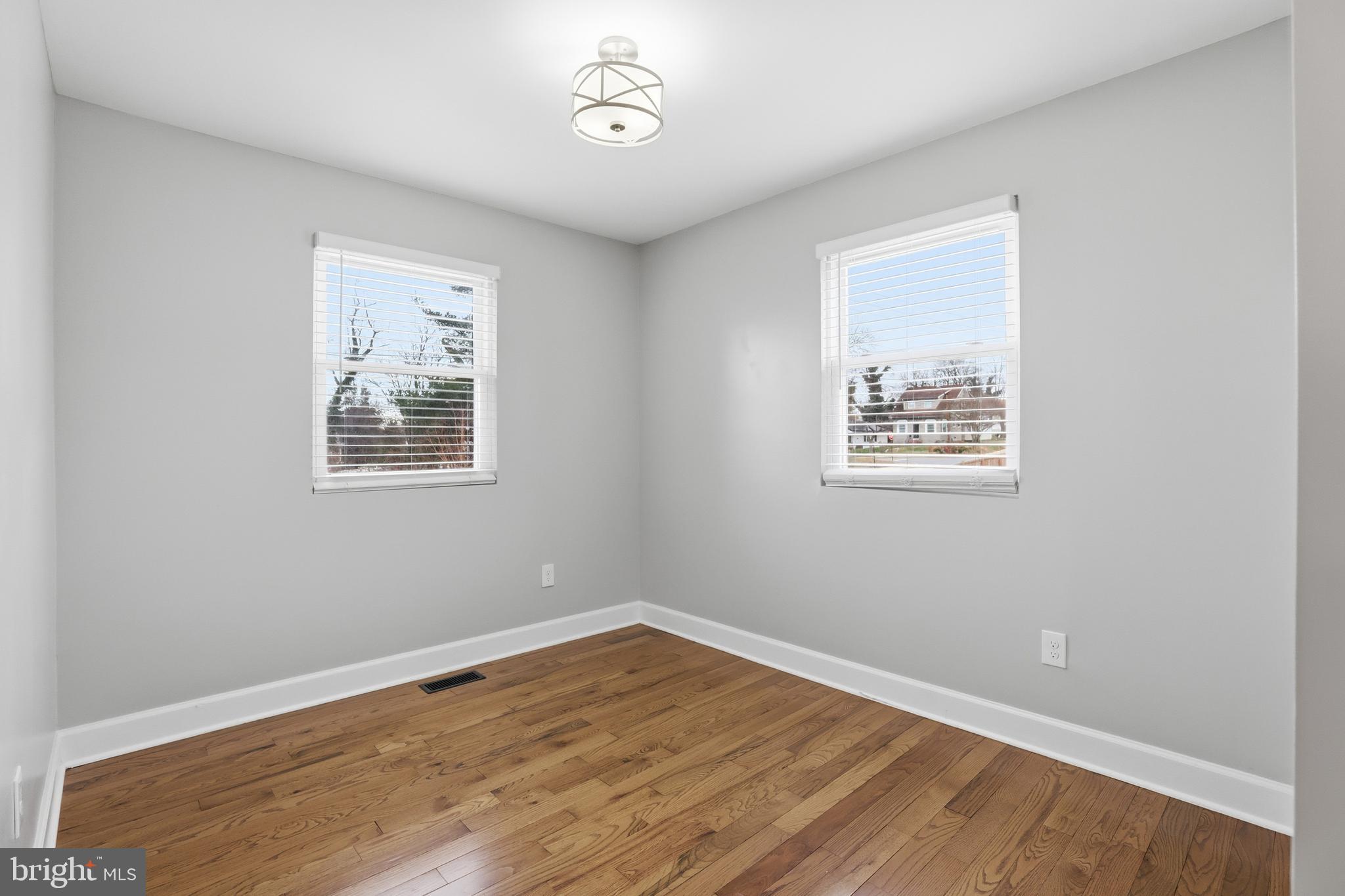211 Jack Street Baltimore, MD 21225 - Photo 12 of 29 a view of empty room with wooden floor