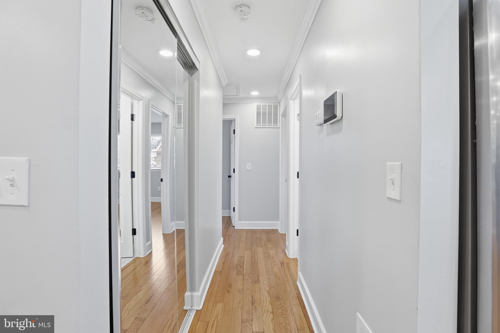 211 Jack Street Baltimore, MD 21225 - Photo 14 of 29 a view of a hallway with wooden floor and a bathroom