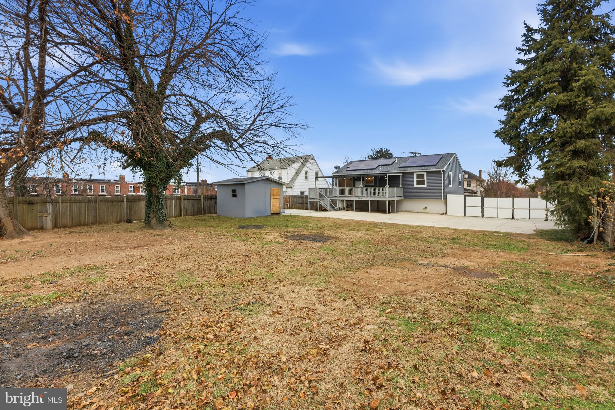 211 Jack Street Baltimore, MD 21225 - Photo 21 of 29 a front view of a house with a yard covered with snow and trees