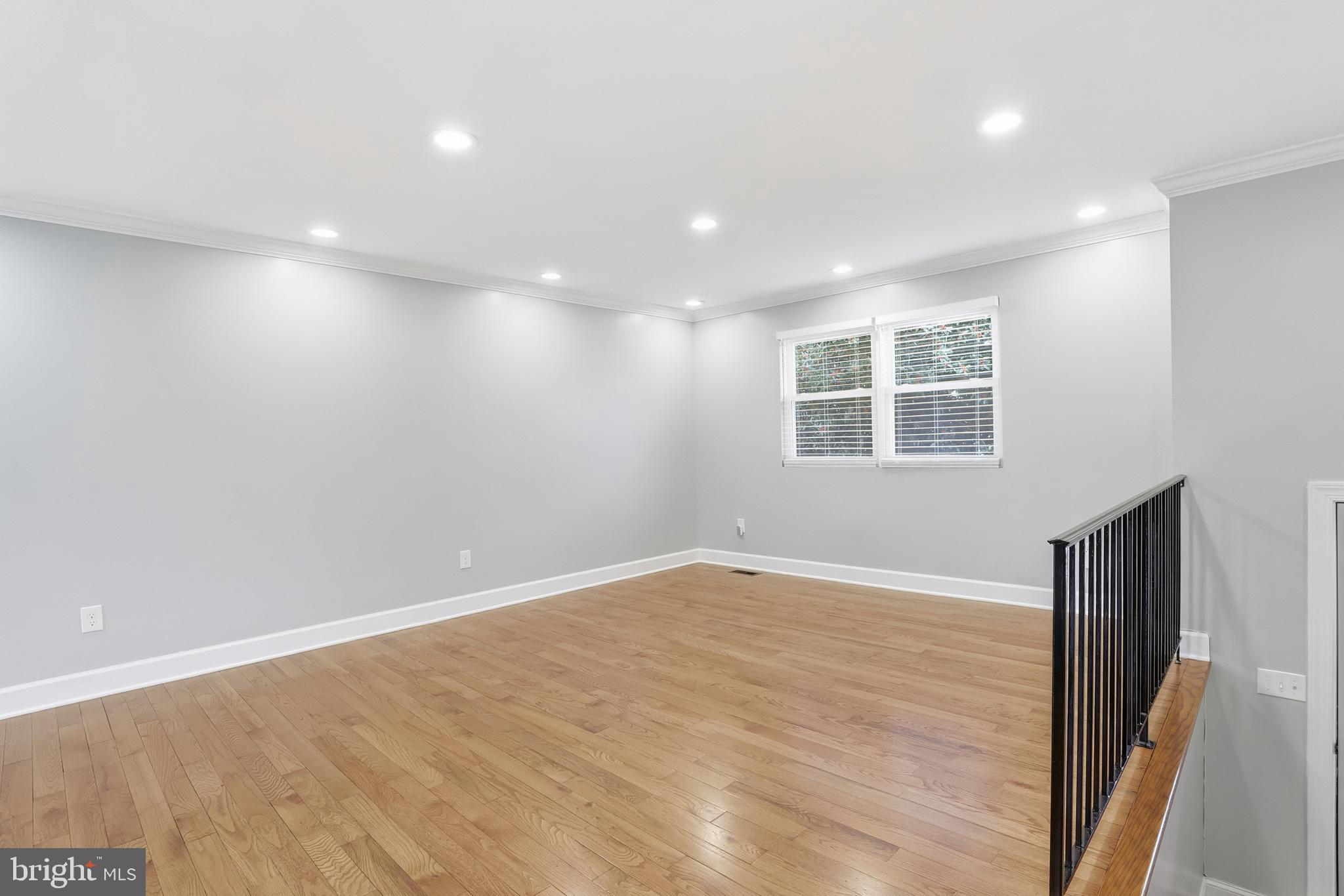 211 Jack Street Baltimore, MD 21225 - Photo 5 of 29 an empty room with windows and closet