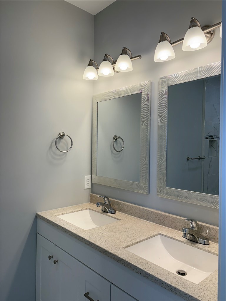 184 Avenue C, Unit M3 Woonsocket, RI 02895 - Photo 5 of 10 Primary bathroom featuring a double-sink vanity and a walk-in shower.