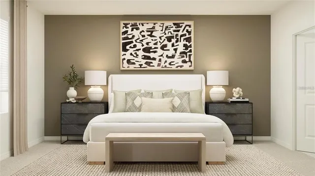 a bedroom with a bed and a lamp on dresser