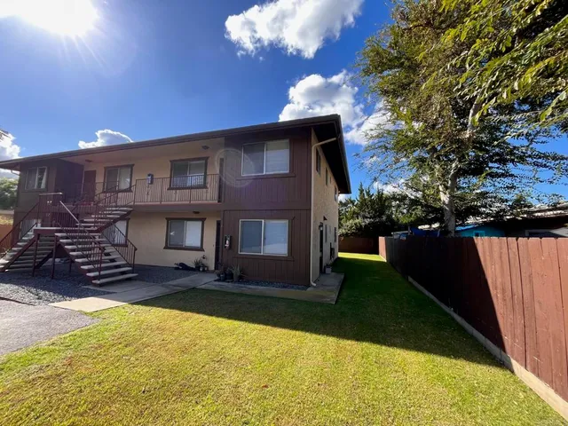 a view of a house with backyard porch and sitting area