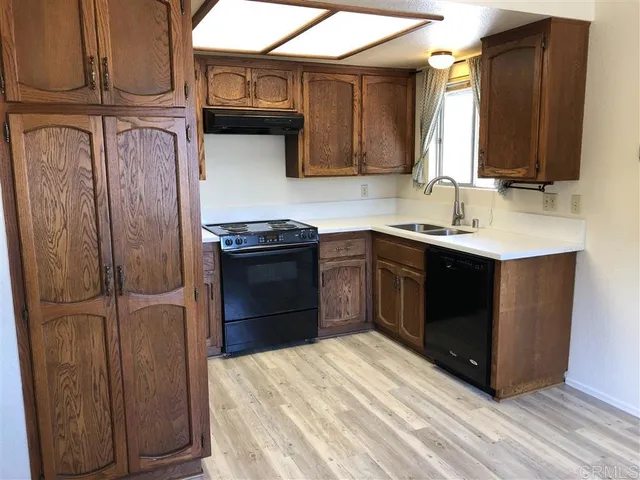 a kitchen with stainless steel appliances granite countertop a stove a refrigerator and a sink