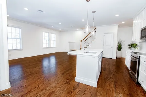 a view of a kitchen and wooden floor