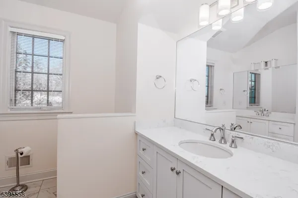 a bathroom with a sink a shower a mirror and a bathtub