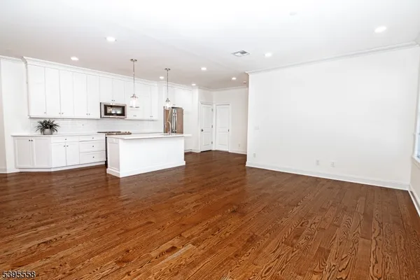 a view of kitchen with wooden floor and window