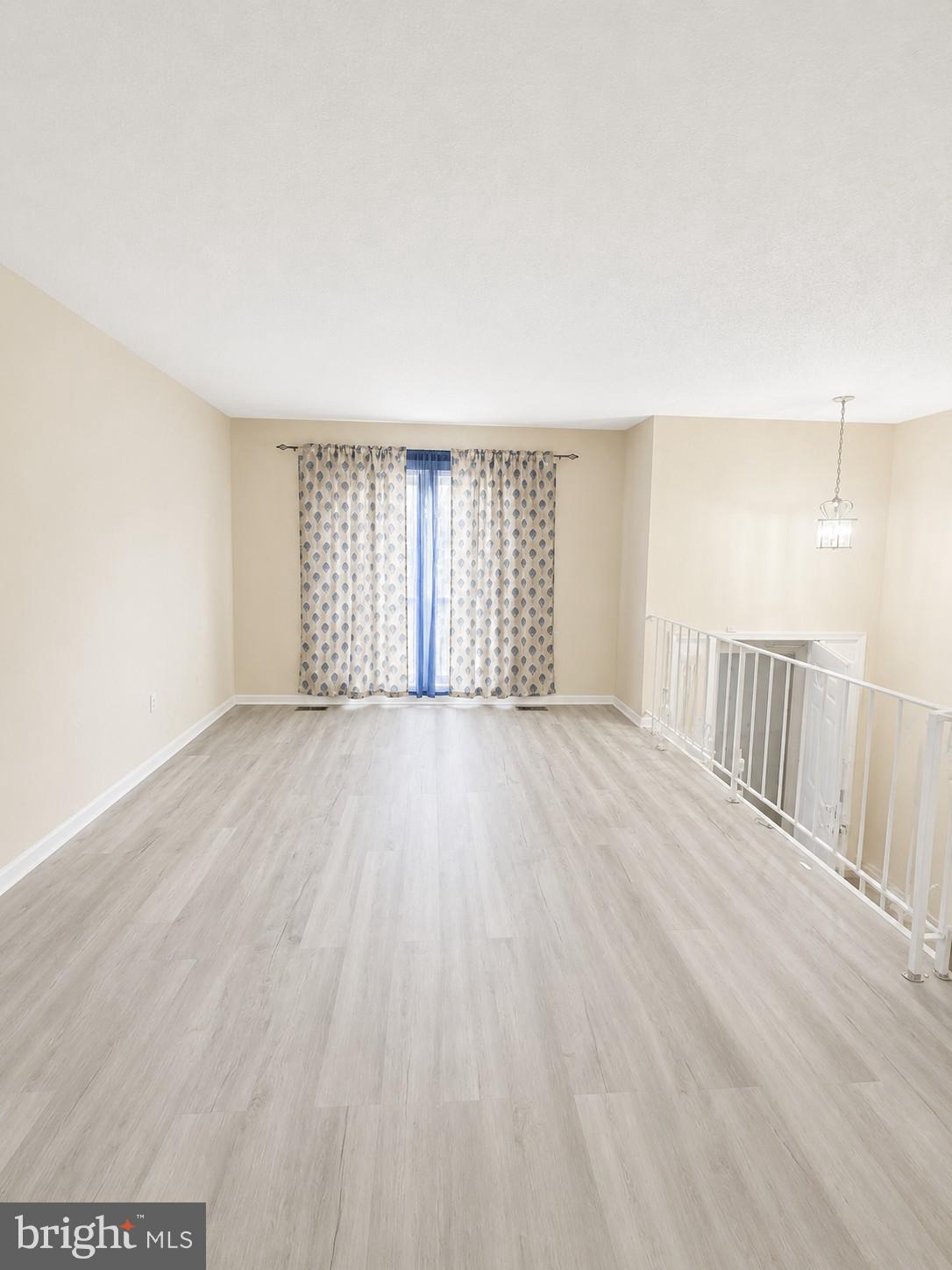 6204 Cipriano Road Lanham, MD 20706 - Photo 3 of 19 wooden floor in an empty room with a window
