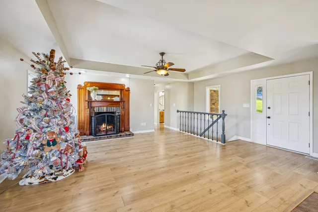a view of a livingroom with hardwood floor and a ceiling fan