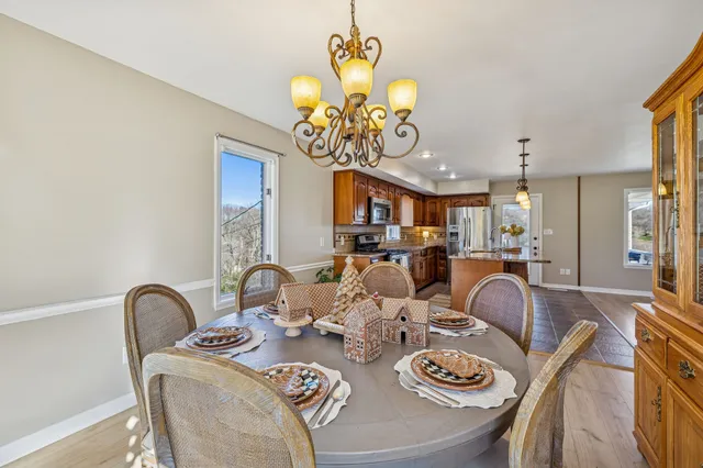 a bedroom with a bed a chandelier and a window