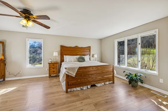 a bedroom with a bed and a window