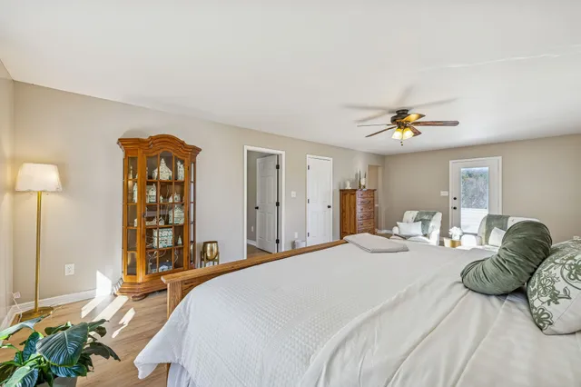 a bedroom with a bed and a wooden floor