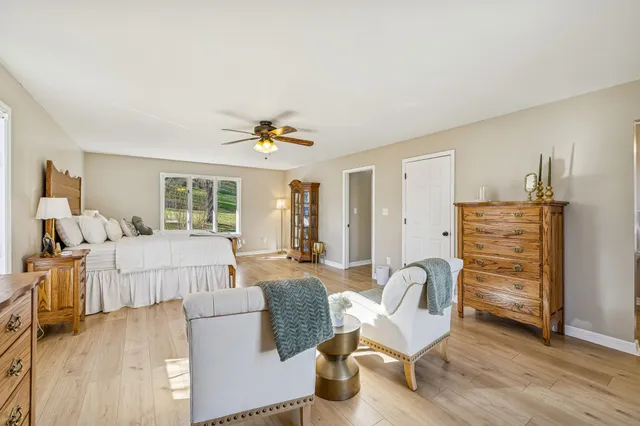 a bedroom with furniture and a wooden floor