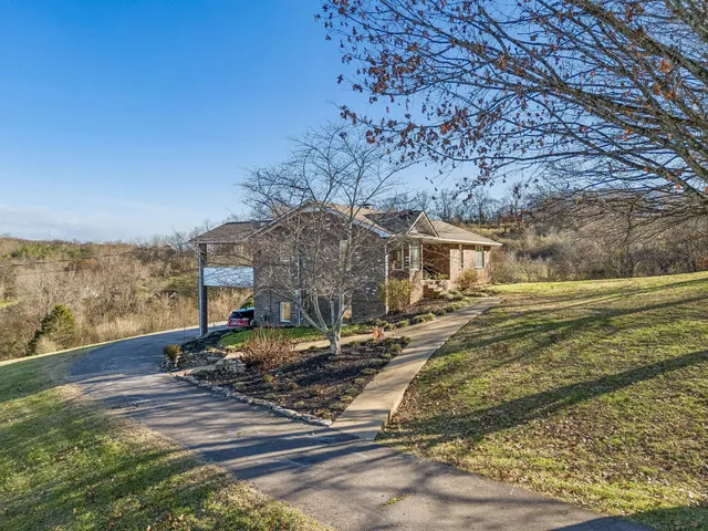 a view of a house with swimming pool and sitting area