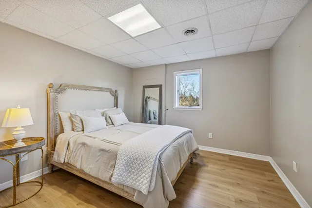 a living room with furniture kitchen view and a large window