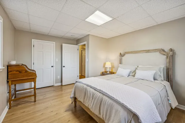a living room with furniture a flat screen tv and a large window