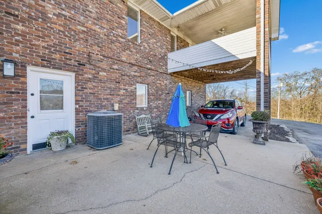 a view of a balcony with furniture and wooden floor