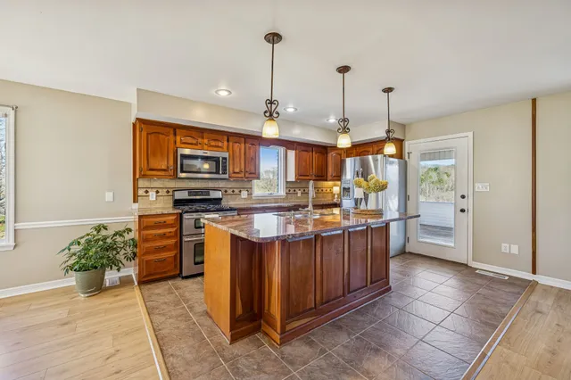 a kitchen with stainless steel appliances granite countertop a stove and refrigerator