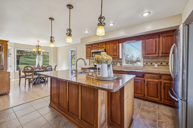 a view of an empty room with a fireplace and a window