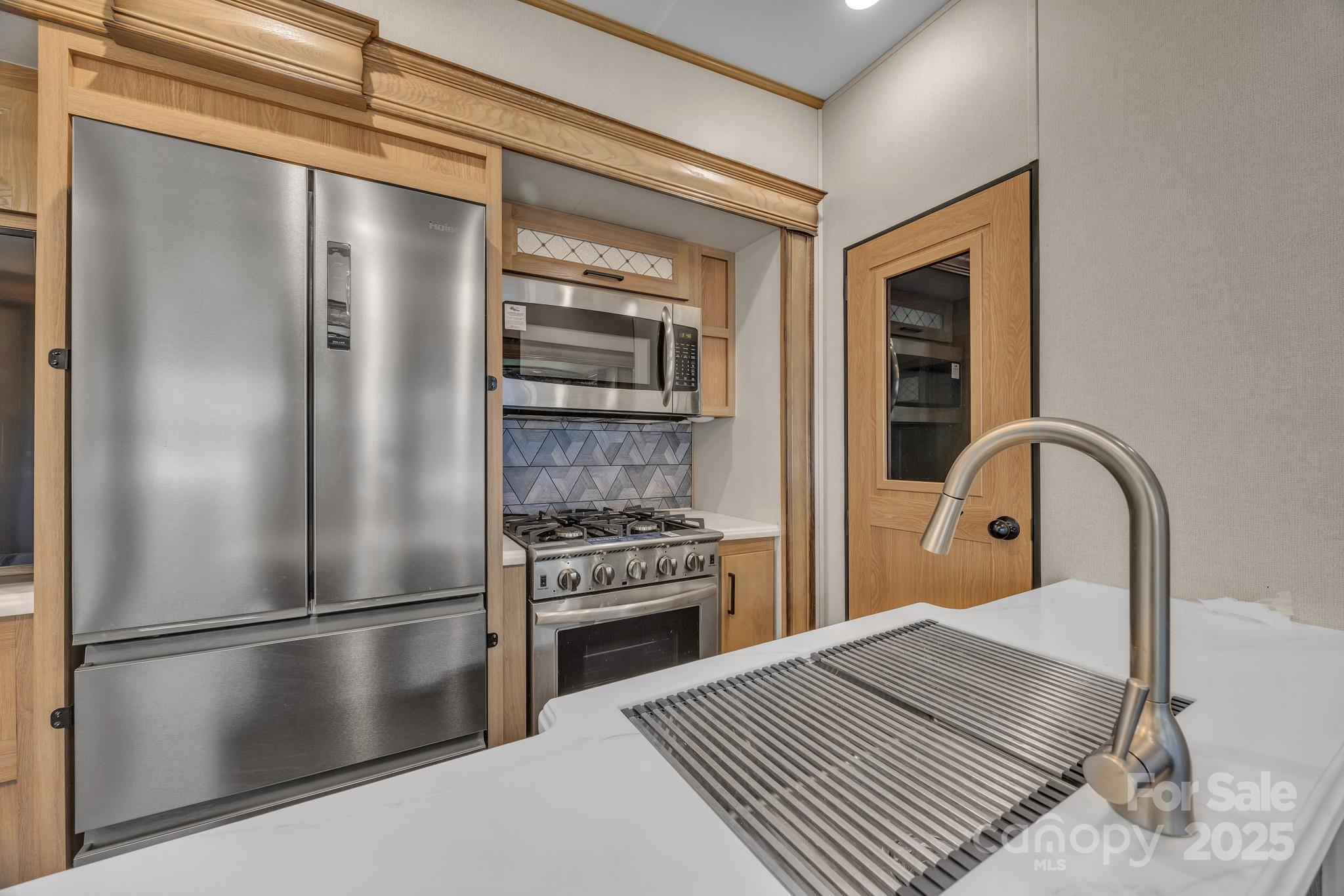 195 Finch Way, Unit 7 West Jefferson, NC 28694 - Photo 15 of 39 a kitchen with a refrigerator and a stove