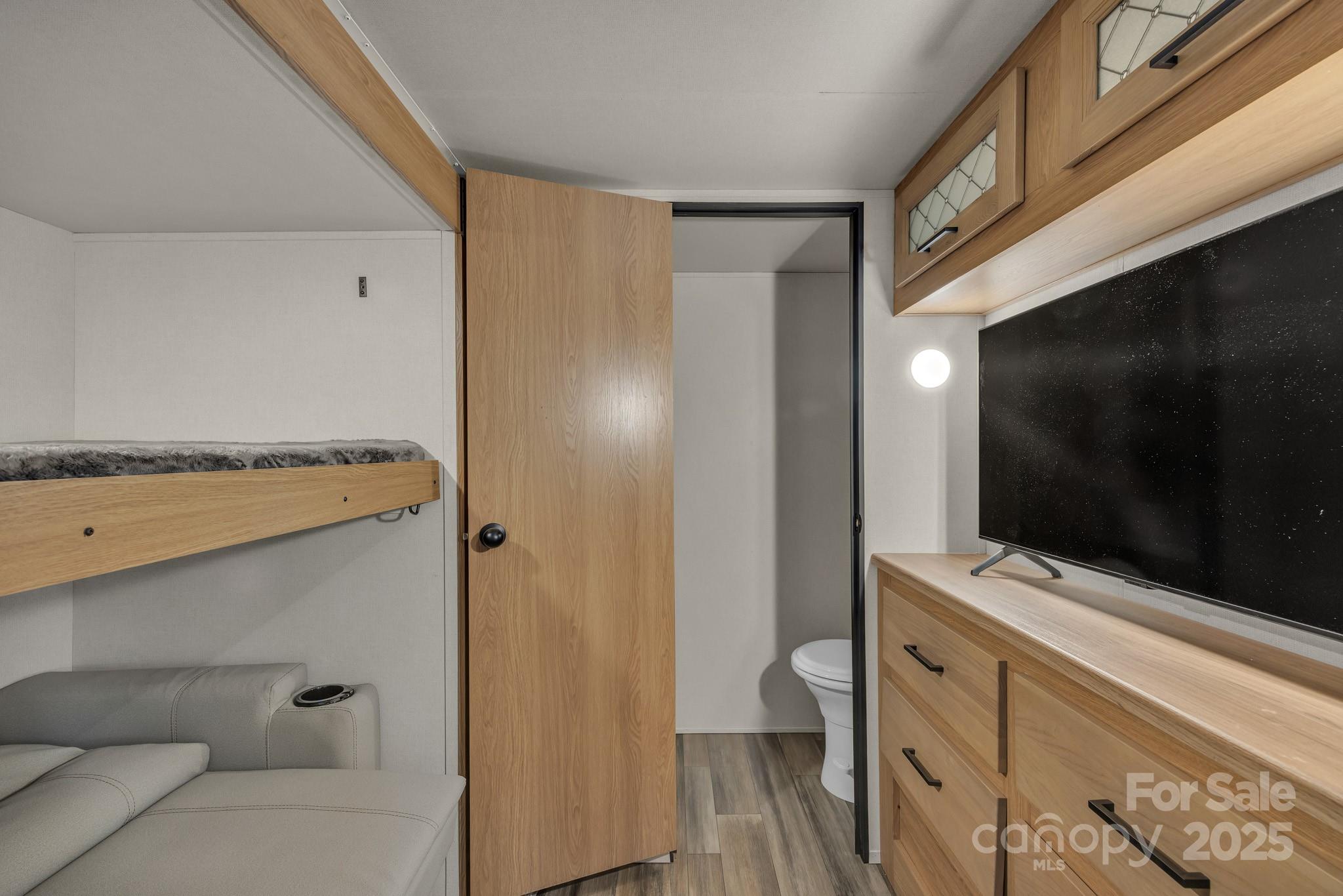 195 Finch Way, Unit 7 West Jefferson, NC 28694 - Photo 21 of 39 a bathroom with a granite countertop sink a mirror and shower