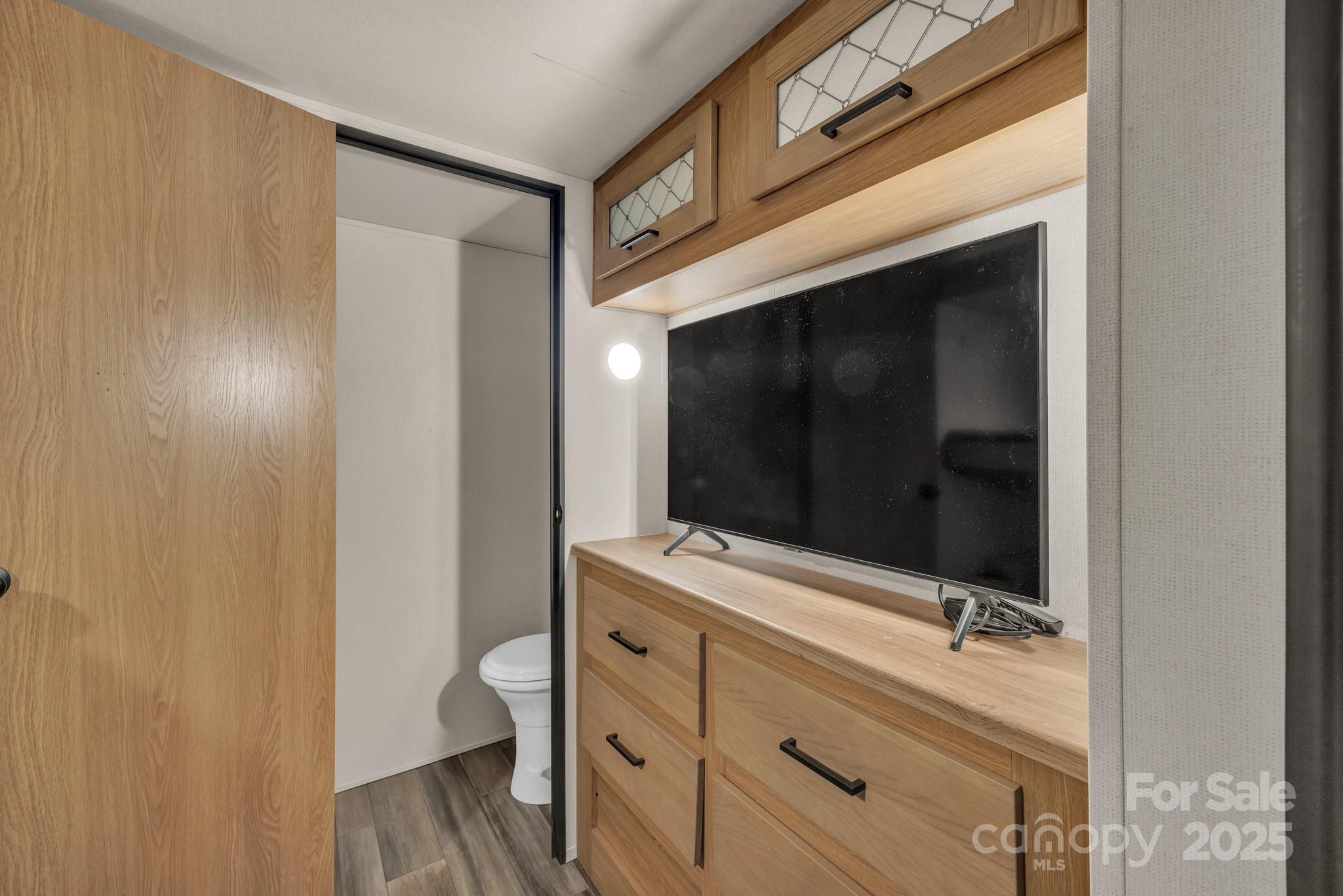 195 Finch Way, Unit 7 West Jefferson, NC 28694 - Photo 22 of 39 a bathroom with a sink a toilet and mirror