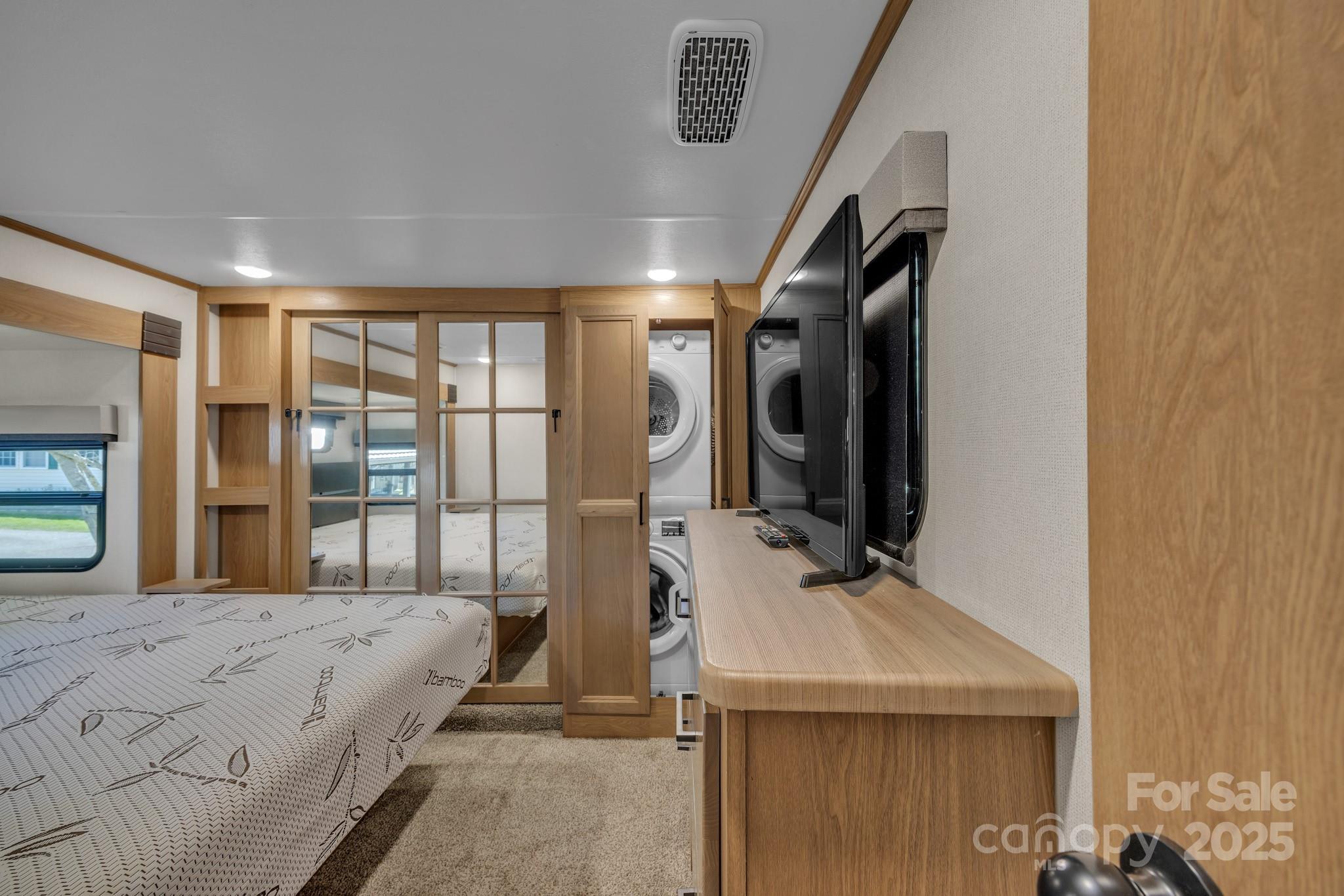 195 Finch Way, Unit 7 West Jefferson, NC 28694 - Photo 23 of 39 a bedroom with a bed and a flat tv screen on wall