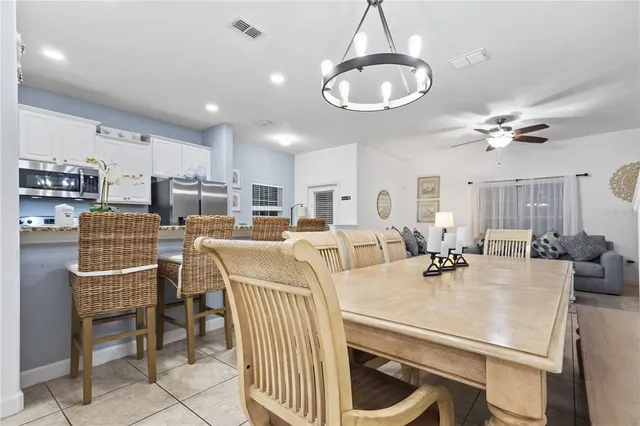 a view of a dining room with furniture and a chandelier