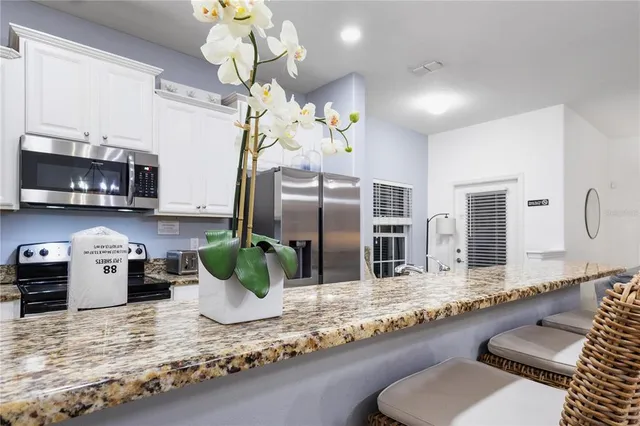 a bathroom with a granite countertop sink a mirror and a shower