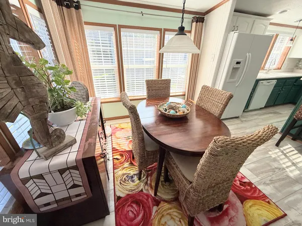 a view of a kitchen with furniture and wooden floor