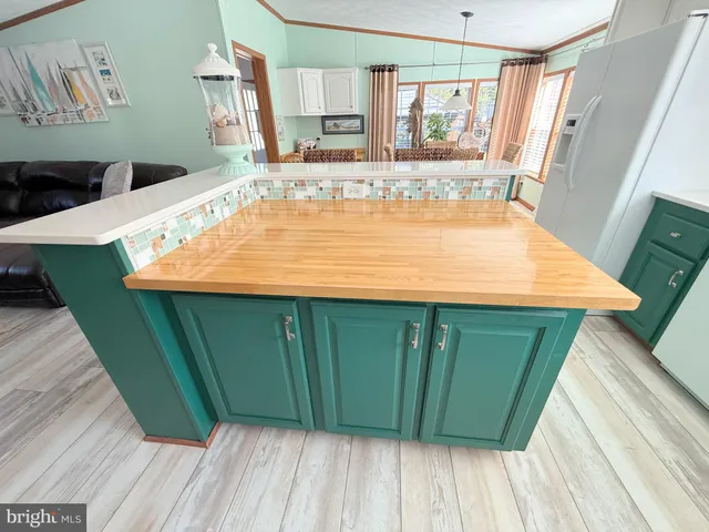 a utility room with a sink window and cabinets