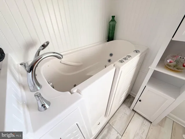 a bathroom with a granite countertop toilet a sink and mirror