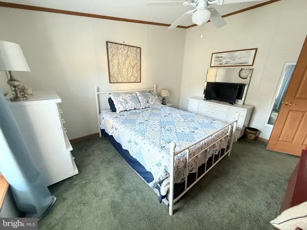 a bedroom with a bed and painting on the wall