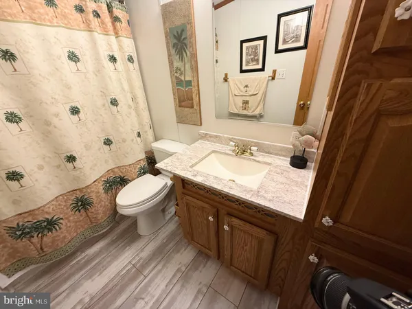 a view of a storage and utility room with refrigerator