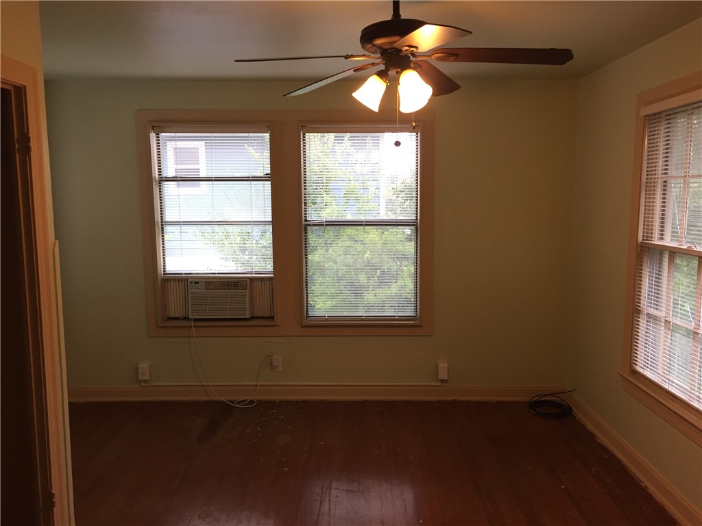 611 West 37th Street, Unit B Austin, TX 78705 - Photo 5 of 9 a view of empty room with wooden floor and fan