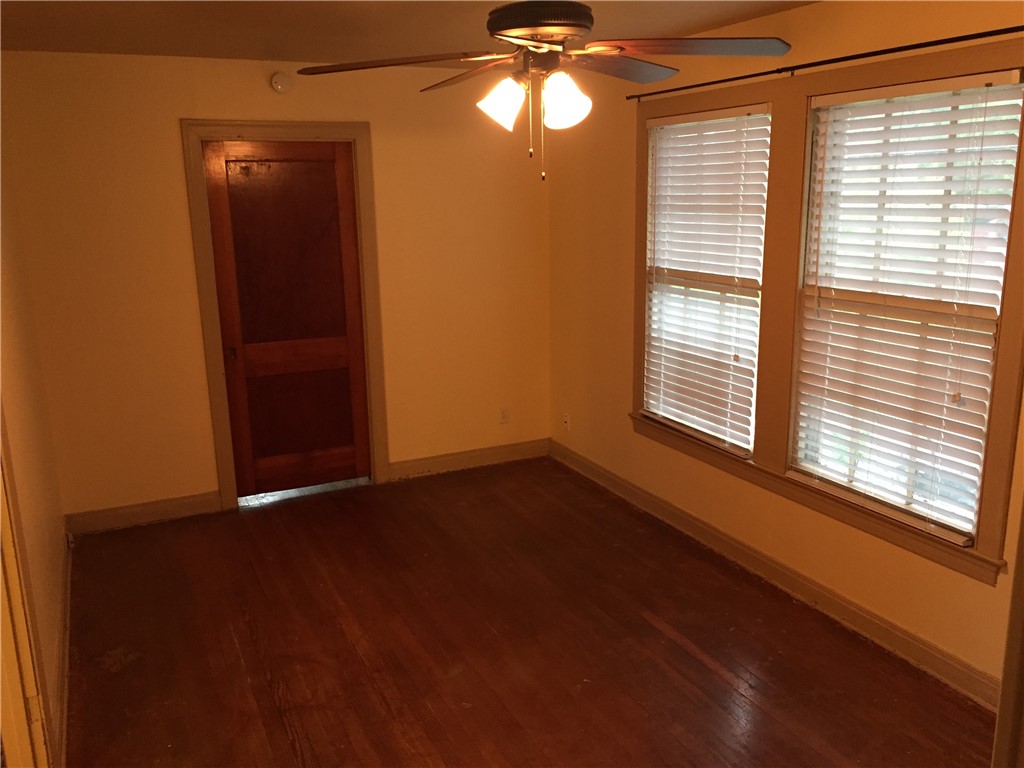 611 West 37th Street, Unit B Austin, TX 78705 - Photo 8 of 9 a view of an empty room with wooden floor and a window