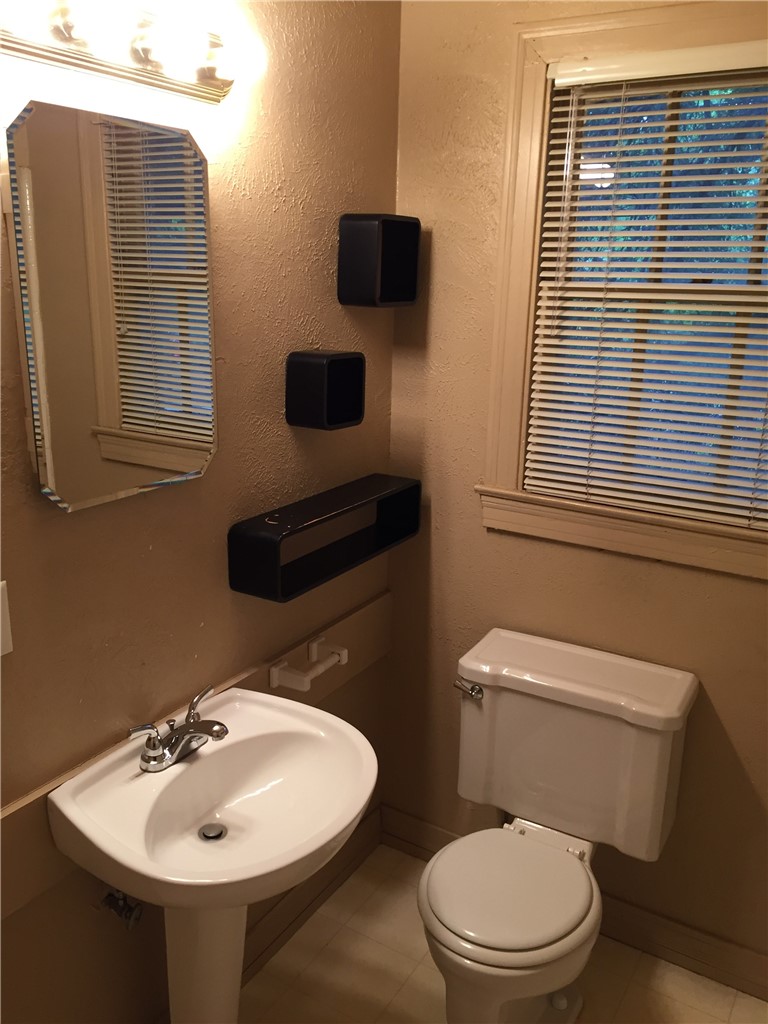 611 West 37th Street, Unit B Austin, TX 78705 - Photo 9 of 9 a bathroom with a toilet sink and mirror